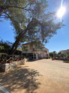 a large building with a tree in front of it at Villa Sofia San Ciro 401 in Ulmi