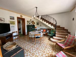a living room with a table and a staircase at Villa Sofia San Ciro 401 in Ulmi