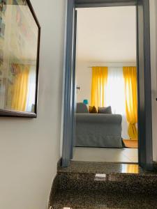 a mirror reflection of a couch in a living room at Dimora Paesana in Alberobello +15 photos