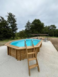 a large swimming pool with a chair in front of it at L'Eperonnette, cozy house with swimming pool, surrounded by vineyard, near St Emilion in Vérac