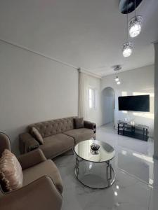a living room with a couch and a table at Modern and comfortable apartment 5km from center in Athens