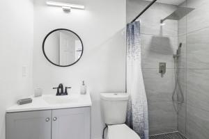 a white bathroom with a toilet and a shower at Spacious 3br Oviedo Home Save 20 Wi-fi in Oviedo +17 photos