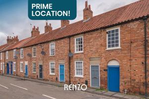 a row of brick houses with the words prime location at Gorgeous 2-bed Home in Newark on-Trent by Renzo, Free Parking, Brilliant Location! in Newark upon Trent