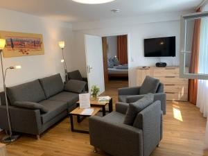 a living room with two couches and a tv at Ferienwohnung Heimweg in Feldberg +57 photos