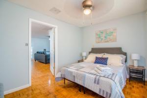 a white bedroom with a bed and a couch at 4br Orlando Home Pets Family Comfort & Deals in Orlando