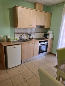 a kitchen with wooden cabinets and a sink and oven at Die kleine Auszeit in Denia