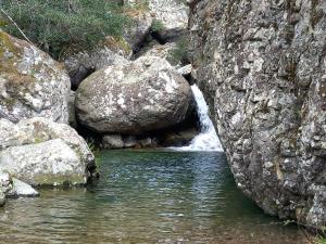 a stream of water in a rocky area with rocks at maison de vacances olmi cappella Corse in Olmi-Cappella +1 photo