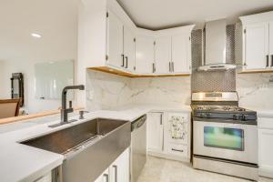 a kitchen with white cabinets and a sink at Chic New Orleans Abode 1 Mi to Lake Pontchartrain in New Orleans