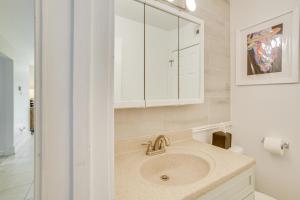 a bathroom with a sink and a white cabinet at Chic New Orleans Abode 1 Mi to Lake Pontchartrain in New Orleans +19 photos