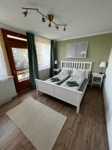 Posteľ alebo postele v izbe v ubytovaní Diána Apartman