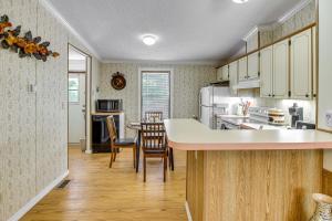 a kitchen with white cabinets and a table with chairs at Crescent City Home with Charcoal Grill Near 3 Lakes in Crescent City