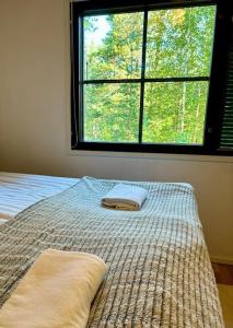 a bed in a bedroom with a large window at Talitintti Levi, 1 bedroom apartment, family friendly in Levi