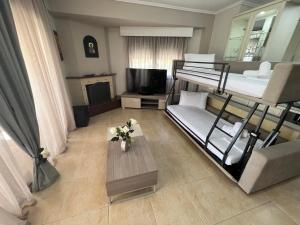 a living room with two bunk beds and a table at Metaxenia's house 101 in Nea Skioni