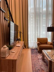 a living room with a television and a couch at Camellia Guesthome Cyberjaya in Cyberjaya