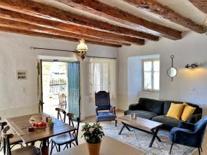a living room with a couch and a table at The house with the arches in Sfakerá