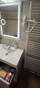 a bathroom with a sink and a mirror at Metaxenia's house 101 in Nea Skioni +62 photos