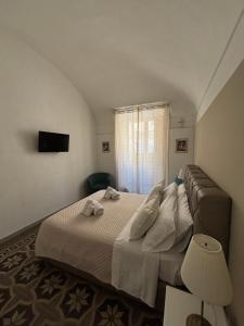 Postel nebo postele na pokoji v ubytování Immacolata Rooms