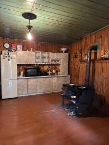 a kitchen with a refrigerator and a table in it at Mukhran&Nargiza guesthouse in Adishi