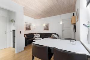 a living room with a table and a couch at Lovely Holiday Apartment Centrally Located In Løkken in Løkken