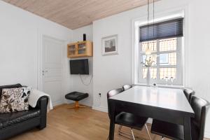 a living room with a couch and a table at Lovely Holiday Apartment Centrally Located In Løkken in Løkken