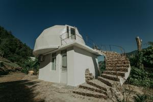 a white building with stairs leading up to it at Amaghlebakari in Batumi