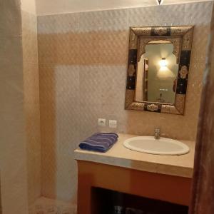 a bathroom with a sink and a mirror at LESCALE DE OUARZAZATE in Ouarzazate +26 photos