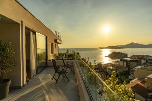 a balcony with chairs and a view of the ocean at Vertmont Villa in Sveti Stefan