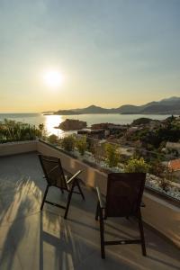 two chairs on a balcony with a view of the ocean at Vertmont Villa in Sveti Stefan