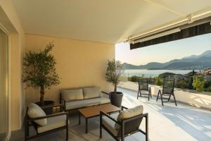 a patio with a couch and a table and chairs at Vertmont Villa in Sveti Stefan