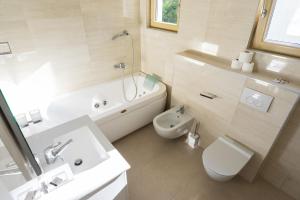 a bathroom with a sink and a toilet and a bath tub at Vertmont Villa in Sveti Stefan