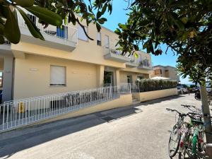 a building with bikes parked in front of it at Hotel Perla in Castiglione della Pescaia