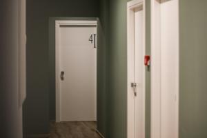 a white door with the number in a room at Hotel Perla in Castiglione della Pescaia