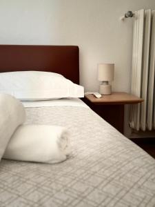 Postel nebo postele na pokoji v ubytování Hotel Locanda Castagnola