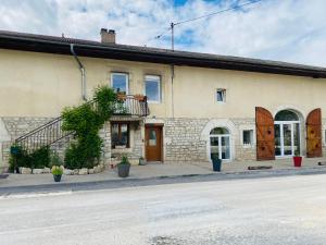 a building with a staircase on the side of it at La Grande Ferme in Arinthod