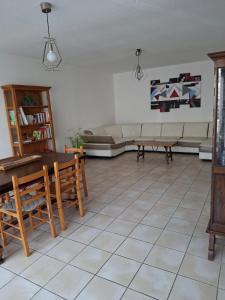 a living room with a couch and a table at La Ferme 3 in Arinthod