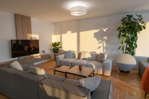 a living room with two couches and a table at Vertmont Villa in Sveti Stefan