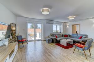 a living room with a couch and a table at Villa Milla in Novi Vinodolski