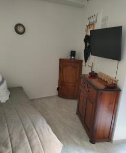 a bedroom with a bed and a flat screen tv at Chante Brise Studio in Cannes