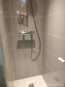 a shower with a hose in a bathroom at Chante Brise Studio in Cannes