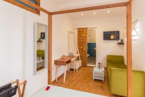 a room with a bed and a desk and a mirror at Dar Korsan in Rabat