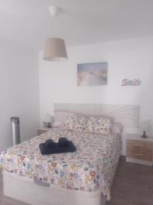 a bedroom with a bed with two pairs of shoes on it at CASA PURICA in Frigiliana