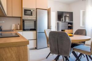 a kitchen with a table and chairs and appliances at Apartment Paradise Island in Pučišća