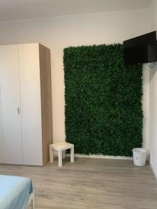 zielony mur w pokoju z łóżkiem i stołem w obiekcie Casa Battisti 15 Settimo Milanese w mieście Settimo Milanese