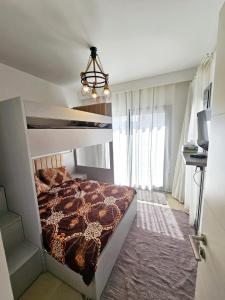 a bedroom with a bed and a chandelier at Townhouse Villa Marassi North Coast in El Alamein +17 photos