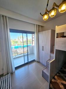 a living room with a view of a balcony at Townhouse Villa Marassi North Coast in El Alamein