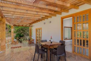 a dining room with a wooden table and chairs at La Dulce Vista Hotel & Villas - Sierra Madre Puerto Vallarta in Puerto Vallarta