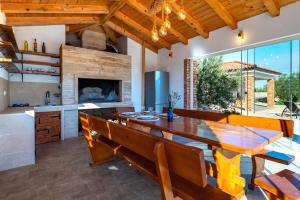 a dining room with a table and chairs and a fireplace at Holiday home Lunnis - Total peace and serenity in Velika Čista