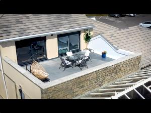 a patio with a table and chairs on top of a house at Fabulous 3-bedroom home across St Michaels Mount in Marazion +5 photos