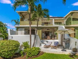 a house with palm trees in front of it at Tamarind Villa - Sugar Hill in Saint James