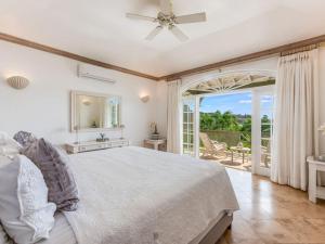 a white bedroom with a bed and a balcony at Tamarind Villa - Sugar Hill in Saint James +12 photos